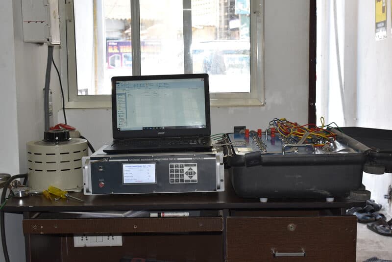 Automatic instrument transformer test set with laptop and variac on calibration workbench at SDES lab