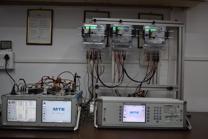 Energy meters under test on calibration rig with MTE PRS 600.3 and K2006 reference standards at SDES lab