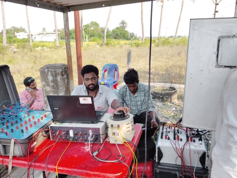 SDES field engineers performing on-site LT meter calibration at a rural substation