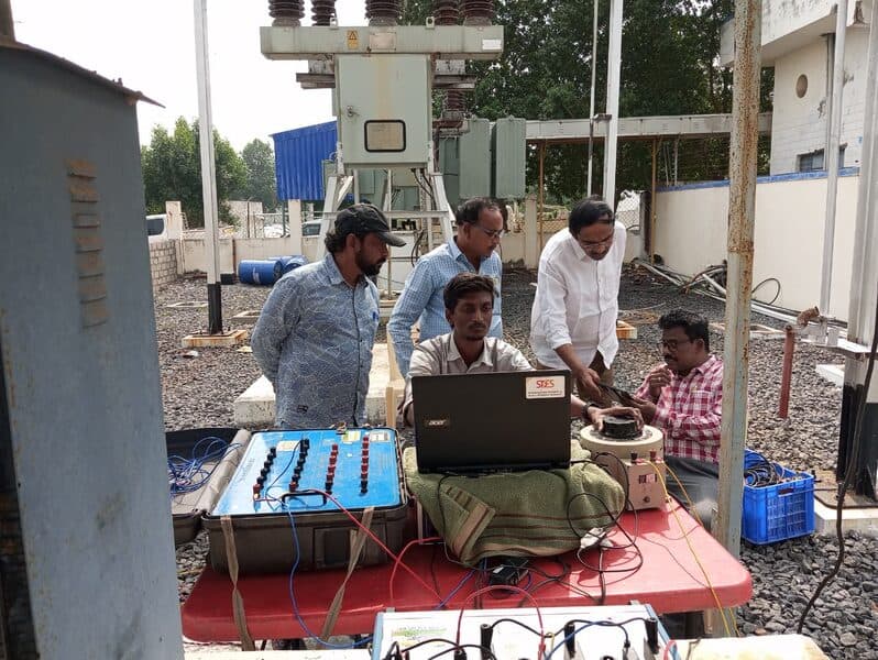 SDES engineers performing instrument transformer calibration at a power substation