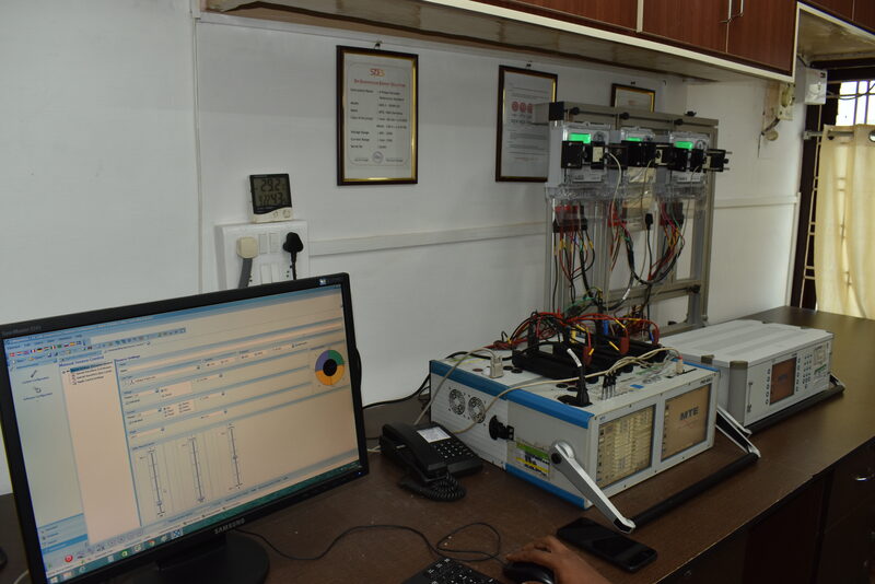 Wide view of SDES energy meter calibration lab showing MTE setup and NABL certificates